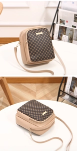Detail showing multi-pocket structure of beige and brown crossbody phone bag with gold hardware