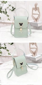Detail view of mint green PU leather mini crossbody bag with metal mouse icon decoration