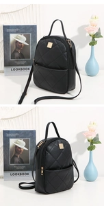 Detail of black quilted mini backpack featuring gold hardware and elegant diamond stitching