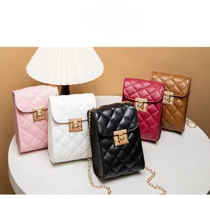 Close-up of diamond quilted crossbody bags in multiple colors with gold chain straps