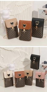 Detail view of mini crossbody mobile phone bags with teddy bear hardware and gold chains