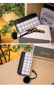 Long zip-around wallet in black faux leather and cream check pattern with furry charm