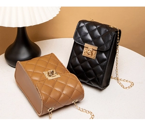 Detailed view of quilted leather crossbody bags in black and brown with gold chain straps