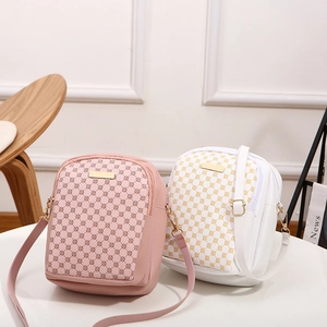 Minimalist crossbody handbags in pink and white with circular pattern and gold hardware