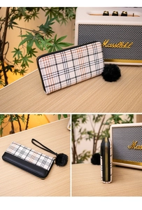 Detailed views of checkered long wallet with black zipper and fuzzy pompom keychain accessory
