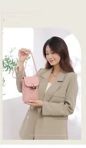 Pink quilted crossbody phone bag with horn toggle closure and slim shoulder strap detail