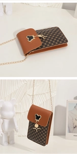 Detailed view of the brown crossbody bag featuring iconic cartoon clasp and golden star charm