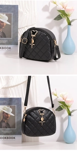 Vue détaillée du sac bandoulière matelassé noir avec finitions dorées et étoile