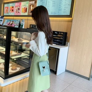 Fashionable mint green mini crossbody bag for women with a sweet heart-shaped pendant