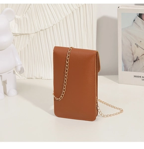 Detail of caramel leather small crossbody phone bag with elegant gold chain strap