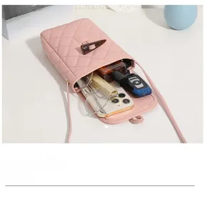 Pink quilted crossbody phone bag with wooden toggle closure and organized essentials
