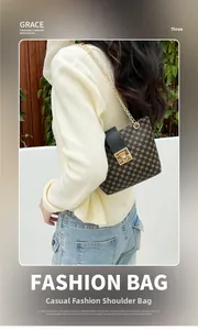Shoulder bag with brown pattern, gold chain strap and turn-lock closure on model