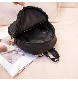 Top view of open black quilted crossbody bag with golden zipper and interior lining