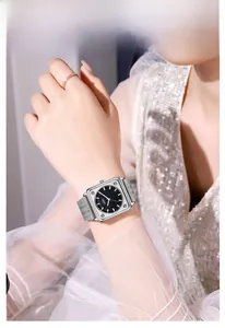 Silver square watch for women with black dial and stainless steel mesh strap on wrist