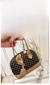 Close-up of printed PVC shell handbag with geometric pattern and round metal zipper