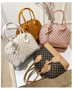 Detailed group view of colorful vintage shell handbags in white, yellow, pink and brown