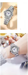 Detailed view of silver stainless steel watch featuring a crystal bezel and Roman numerals