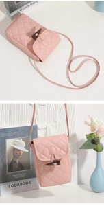 Detail of pink quilted PU leather mini crossbody bag with dark brown toggle closure