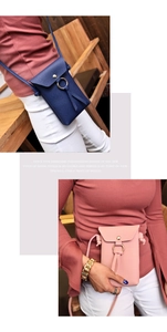 Detail of minimalist pebble leather crossbody phone bags with circular metal buckles