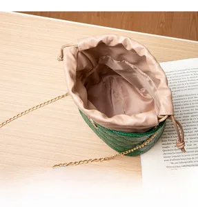 Top view of deep green quilted bucket bag showing spacious interior and golden chain strap