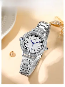 Close-up of luxury women's quartz watch with crystal bezel and blue cabochon crown