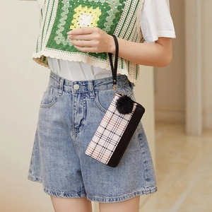 Women's plaid print wristlet clutch purse with pompom charm and leather trim