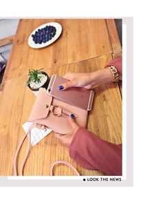 Pink lychee texture mini crossbody bag shown with a smartphone for size scale