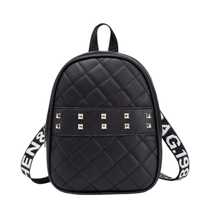 Black quilted mini backpack with gold studs and lettered contrast crossbody strap