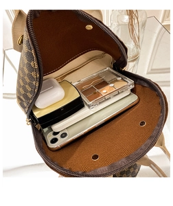 Interior view of brown vintage shell bag showing large storage capacity for gadgets