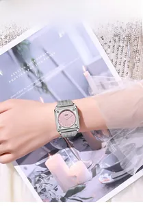 Elegant silver square watch with pink dial and milanese mesh strap on model wrist