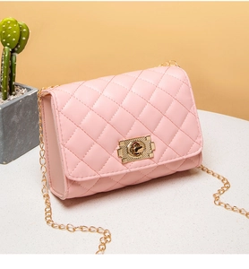 Detailed side view of pink quilted handbag with gold chain strap and metal clasp