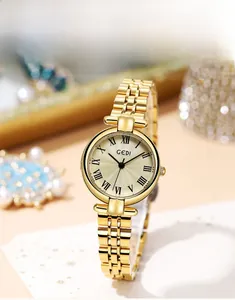 Close-up of GEDI vintage roman numeral watch face with elegant sunburst texture gold dial