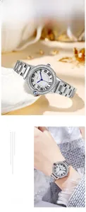 Detail of silver quartz watch featuring a diamond bezel and classic blue sword hands