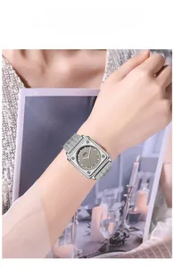 Close-up of elegant square silver mesh strap watch with minimalist grey dial for women