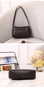 Detail view of coffee shoulder bag with back zipper pocket and quilted base texture