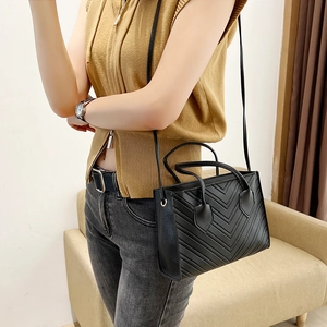 Classic black chevron quilted tote bag with top handles and slender shoulder straps