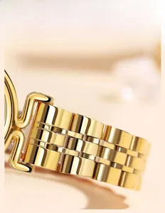 Macro shot of polished gold five-link solid stainless steel watch strap with mirror finish
