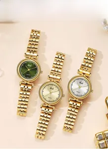Three elegant Gedi quartz watches with gold steel bands in emerald, gold, and silver dials