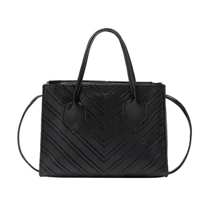 Elegant black chevron quilted mini handbag with dual handles and slim shoulder strap