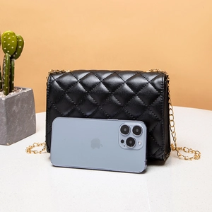 Quilted black chain crossbody bag shown with a smartphone for size reference