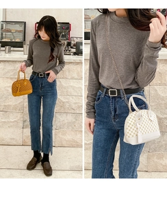 Detailed view of fashionistas carrying printed shell handbags with chain straps