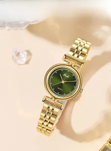 Close-up of golden steel watch featuring a vintage dark green sunray dial and quartz movement