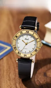 Macro shot of vintage quartz watch with gold case, Roman numerals on wood background