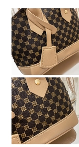 Detail of printed shell bag showing brown monogram pattern and beige stitched handles