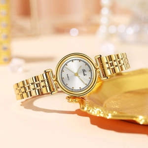 Elegant gold stainless steel women's quartz watch with silver sunray dial on luxury tray