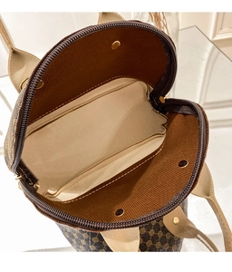 Detailed interior of vintage brown shell bag showing spacious lining and zipper
