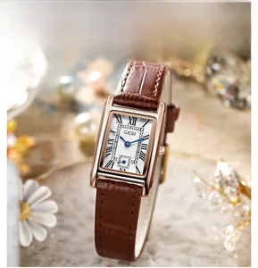 Macro detail of retro square quartz watch with brown leather strap and roman numerals