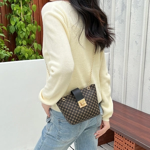 Diamond pattern chain bucket bag in brown canvas with black leather flap and gold lock
