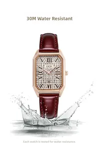 Macro shot of rose gold rectangular watch in splashing water highlighting 3ATM waterproof