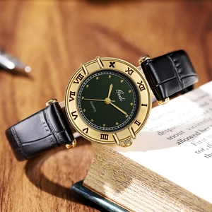 Vintage women's quartz watch with gold roman numeral bezel and dark green dial